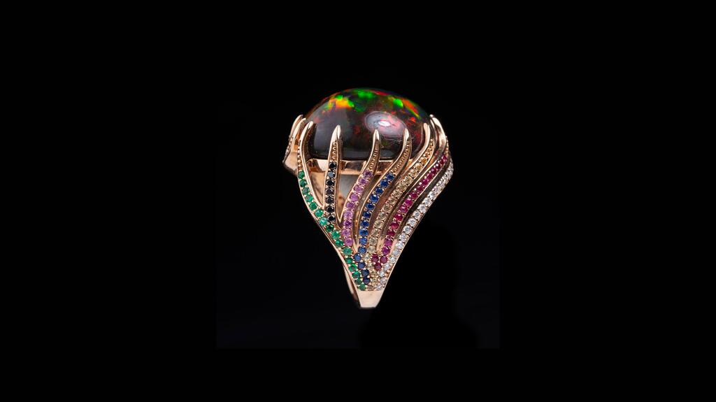 Heard Gallery in San Antonio, Texas, designed by Susan Oliver Heard. An 18-karat rose gold ring with 0.25 carats of emeralds, 0.20 carats of sapphires, 0.025 carats of rubies, 0.10 carats of black diamonds, and 0.25 carats of white diamonds that swirl around a 16.80-carat Ethiopian opal at the center of the piece ($18,600) Heard Gallery Ring